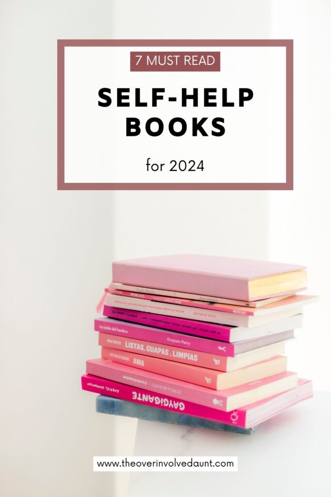 Stack of pink books on a table. Pinterest image for the blog post 7 Interesting Self-Books to Change You.